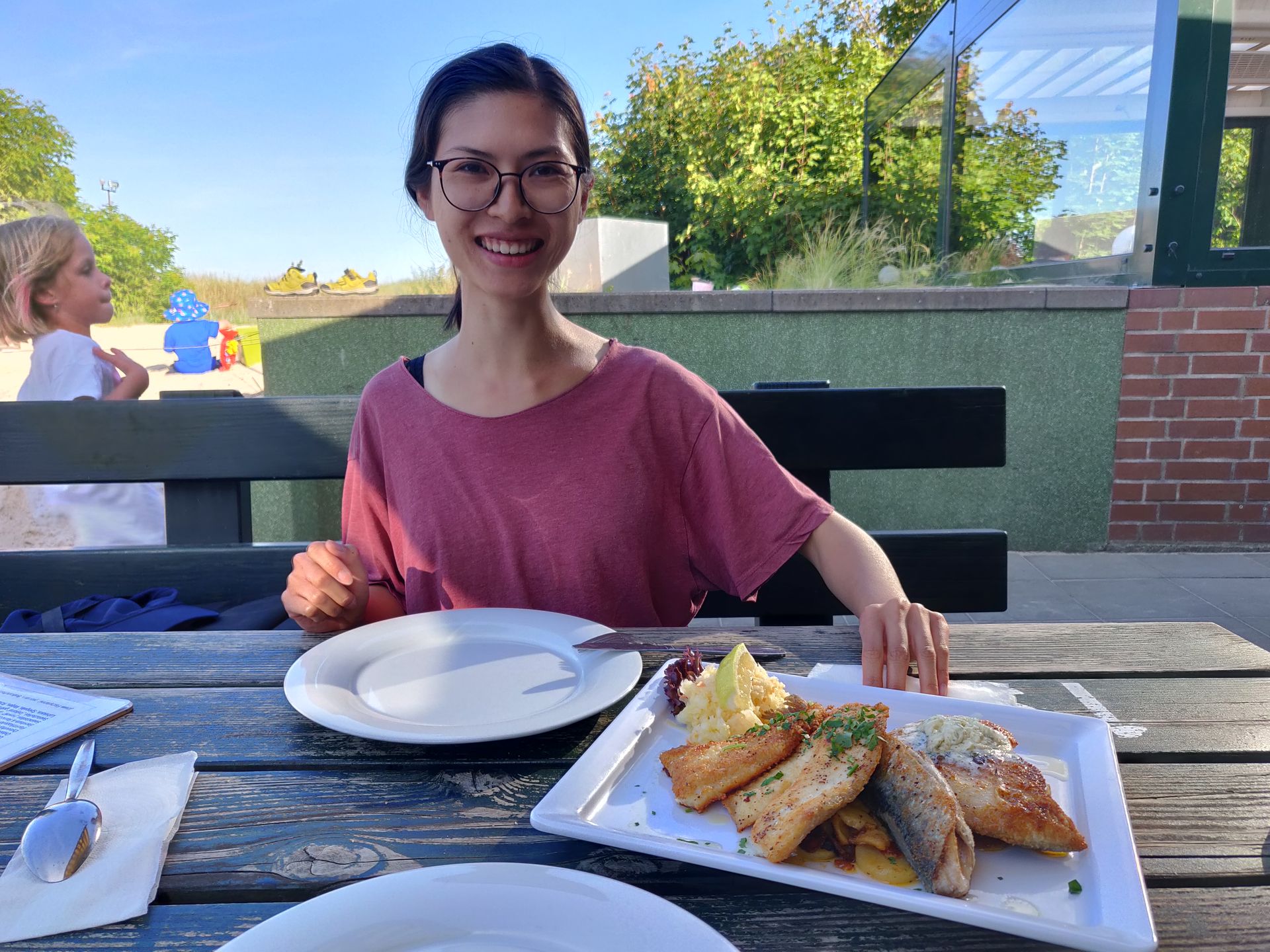 Clara mange une Fischplatte à Uwe's Fischerhütte